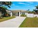 Charming single-story home features a well-manicured lawn and a concrete driveway at 2410 26Th S St, St Petersburg, FL 33712
