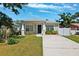 Charming single-story home features a well-manicured lawn and a concrete driveway at 2410 26Th S St, St Petersburg, FL 33712