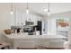 Modern kitchen featuring white cabinets, a breakfast bar, and stainless steel appliances at 2410 26Th S St, St Petersburg, FL 33712