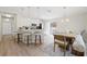 Open-concept kitchen and dining area with modern barstool seating and stainless steel appliances at 2410 26Th S St, St Petersburg, FL 33712