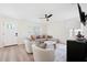 Bright living room with modern furniture, stylish rug, ceiling fan and a decorative front door at 2410 26Th S St, St Petersburg, FL 33712