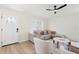 Bright living room with modern furniture, stylish rug, ceiling fan and a decorative front door at 2410 26Th S St, St Petersburg, FL 33712