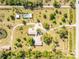 Expansive property with a house, pool, pond, lush greenery, and a winding driveway at 24549 Nova Ln, Punta Gorda, FL 33980
