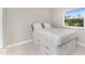 Bright bedroom featuring a minimalist design, ample storage, and a sun-filled window view at 24549 Nova Ln, Punta Gorda, FL 33980