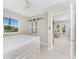 Bedroom with a sliding barn door and large windows that overlook lush green trees at 24549 Nova Ln, Punta Gorda, FL 33980