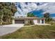 Single story home featuring a well-maintained lawn, neutral paint, and an attached two-car garage at 24549 Nova Ln, Punta Gorda, FL 33980