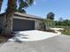 Modern home featuring an attached garage, fresh concrete driveway, and tastefully landscaped front yard at 24549 Nova Ln, Punta Gorda, FL 33980