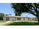 Charming single-story home with a well-manicured lawn and mature tree providing ample shade at 24549 Nova Ln, Punta Gorda, FL 33980