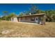 Exterior shot showcasing the property's facade and landscaping on a sunny day at 24549 Nova Ln, Punta Gorda, FL 33980