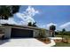 Single story home boasting a modern exterior, landscaped yard, and attached garage at 24549 Nova Ln, Punta Gorda, FL 33980