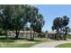 Expansive property featuring a modern home design complemented by mature trees and lush landscaping at 24549 Nova Ln, Punta Gorda, FL 33980