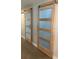Hallway featuring modern barn doors with glass panels at 24549 Nova Ln, Punta Gorda, FL 33980