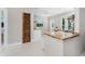 Modern kitchen with butcher block countertops, open shelving, and ample natural light at 24549 Nova Ln, Punta Gorda, FL 33980
