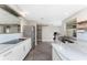 Modern kitchen featuring white cabinets, stainless steel appliances, and a sliding barn door at 24549 Nova Ln, Punta Gorda, FL 33980
