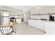 Modern kitchen with stainless steel appliances, white cabinets, and butcher block countertops at 24549 Nova Ln, Punta Gorda, FL 33980