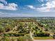 Sprawling acreage outlined in red, featuring lush greenery, mature trees, and structures at 24549 Nova Ln, Punta Gorda, FL 33980