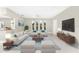 Bright living room featuring neutral furniture, a stylish rug, and views through large windows at 24549 Nova Ln, Punta Gorda, FL 33980