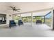 Spacious screened patio with modern furniture and view of the outdoor landscape at 24549 Nova Ln, Punta Gorda, FL 33980
