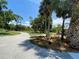 Lush grounds of a home, featuring mature trees, open green spaces, and a curving driveway at 24549 Nova Ln, Punta Gorda, FL 33980