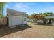 A view of the backyard shed with a white garage door with a manicured lawn at 2610 58Th S St, Gulfport, FL 33707