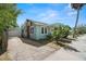 Charming blue home with a brick chimney and mature landscaping at 2610 58Th S St, Gulfport, FL 33707
