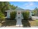 Charming, light blue home featuring a welcoming entrance and well-maintained landscaping at 2610 58Th S St, Gulfport, FL 33707