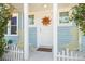 Front porch with chairs, a sunburst decoration, and a welcome mat on a bright day at 2610 58Th S St, Gulfport, FL 33707
