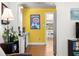 Kitchenette with bright yellow walls, wood floors, and stainless steel appliances at 2610 58Th S St, Gulfport, FL 33707