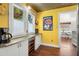 Cozy kitchenette with white cabinets, stainless countertop, and decorative accents at 2610 58Th S St, Gulfport, FL 33707