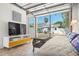 Comfortable living space with a view of the fenced backyard, TV, and outdoor seating area at 2610 58Th S St, Gulfport, FL 33707