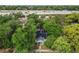 Overhead view of a home with solar panels, mature trees, and nearby highway access at 2708 N Mitchell Ave, Tampa, FL 33602