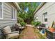Secluded backyard oasis featuring comfortable seating, lush greenery, and a tranquil atmosphere perfect for relaxation at 2708 N Mitchell Ave, Tampa, FL 33602