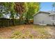 Large fenced backyard features a firepit and seating, perfect for outdoor entertaining at 2708 N Mitchell Ave, Tampa, FL 33602
