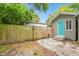 Backyard with gray exterior and turquoise door features a fenced area and additional shed at 2708 N Mitchell Ave, Tampa, FL 33602