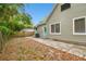 Charming backyard with a gray exterior, turquoise door, and fenced-in yard at 2708 N Mitchell Ave, Tampa, FL 33602