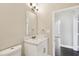 Neat bathroom with a classic mirror, modern vanity, and toilet for basic needs at 2708 N Mitchell Ave, Tampa, FL 33602