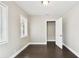 Well-lit bedroom with dark wood flooring, closet, and large windows at 2708 N Mitchell Ave, Tampa, FL 33602