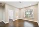 Bright bedroom features hardwood floors, a walk-in closet, and natural light from a large window at 2708 N Mitchell Ave, Tampa, FL 33602