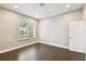 Well-lit bedroom with hardwood floors and a window for sunlight, offering a blank canvas for personalization at 2708 N Mitchell Ave, Tampa, FL 33602