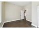 Bright bedroom with a neutral color palette, hardwood floors, and an open doorway to another room at 2708 N Mitchell Ave, Tampa, FL 33602