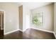 Cozy bedroom with hardwood floors, a window with tree views, and a closet for ample storage at 2708 N Mitchell Ave, Tampa, FL 33602