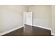 Simple bedroom featuring hardwood floors, a window, and a doorway for straightforward living at 2708 N Mitchell Ave, Tampa, FL 33602