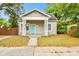 Charming single story home with a covered front porch and a welcoming blue door at 2708 N Mitchell Ave, Tampa, FL 33602