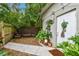 Backyard exterior showcasing a quaint sitting area with a garden and a peaceful ambiance at 2708 N Mitchell Ave, Tampa, FL 33602