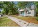 Traditional home featuring a well-kept lawn, a private driveway, and mature trees at 2708 N Mitchell Ave, Tampa, FL 33602