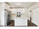 Modern kitchen featuring white cabinets, stainless steel appliances, and a center island at 2708 N Mitchell Ave, Tampa, FL 33602