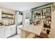 Bright kitchen features white cabinets, open shelving, breakfast bar, stainless steel faucet and adjacent stacked washer/dryer at 2708 N Mitchell Ave, Tampa, FL 33602
