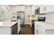 Contemporary kitchen with stainless steel appliances, granite countertops, and white cabinetry at 2708 N Mitchell Ave, Tampa, FL 33602