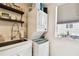 Close-up view of the stacked washer and dryer with a large sink and countertop nearby under the window at 2708 N Mitchell Ave, Tampa, FL 33602