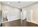 Spacious living room with hardwood floors leads to kitchen and bathroom with white subway tile at 2708 N Mitchell Ave, Tampa, FL 33602